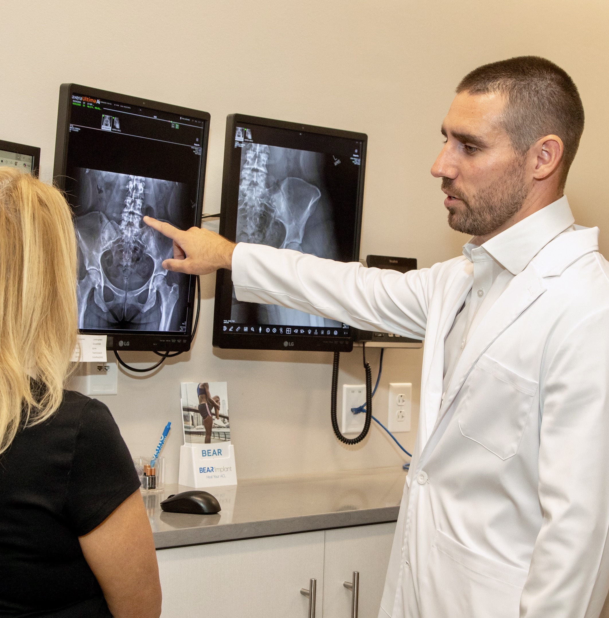 Dr. Michael Pompliano reviewing spine X-rays with a patient